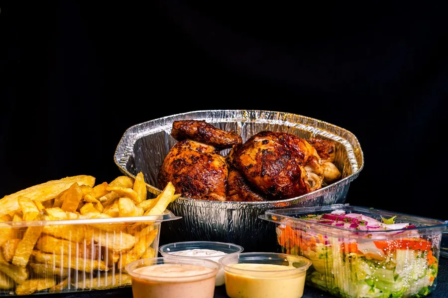 Pollo a la brasa con papas doradas, ensalada y cremas de la casa